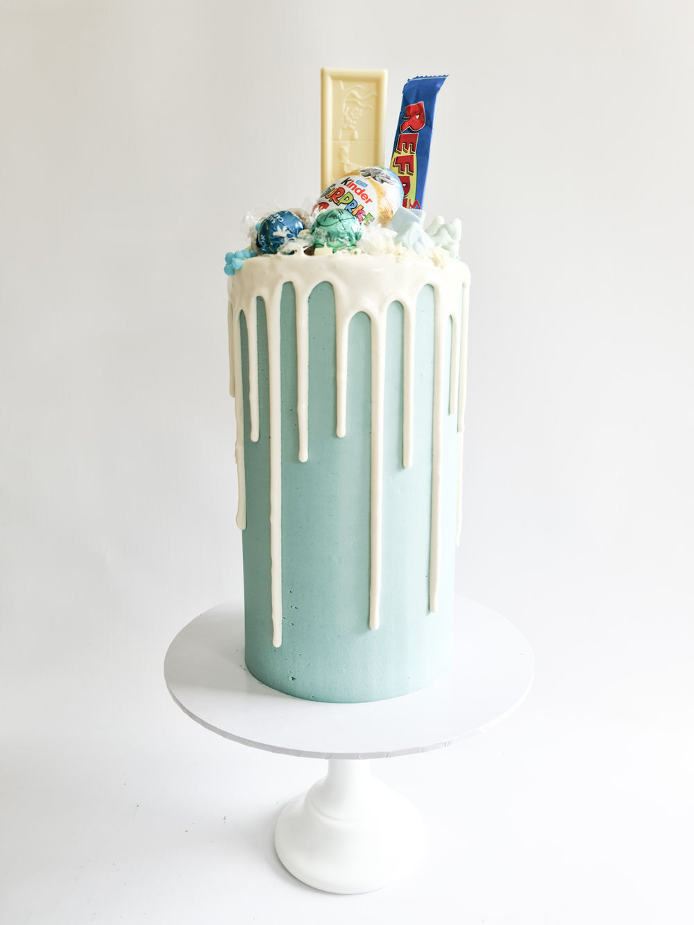 Blue fully loaded drip cake for birthday celebration on the Isle of Man