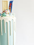 Blue fully loaded drip cake for birthday celebration on the Isle of Man