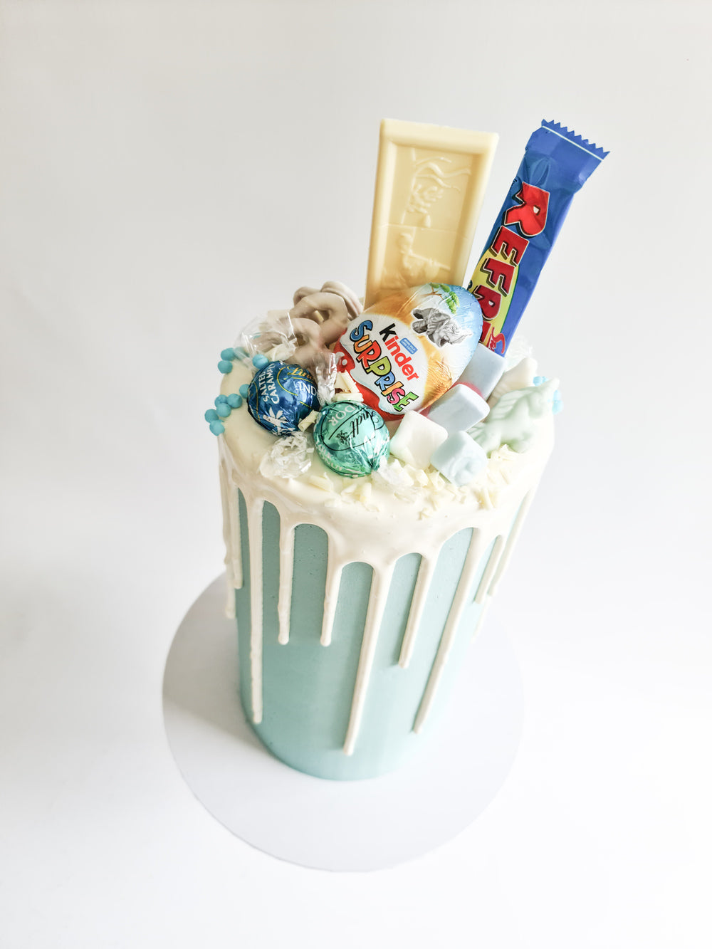 Blue fully loaded drip cake for birthday celebration on the Isle of Man