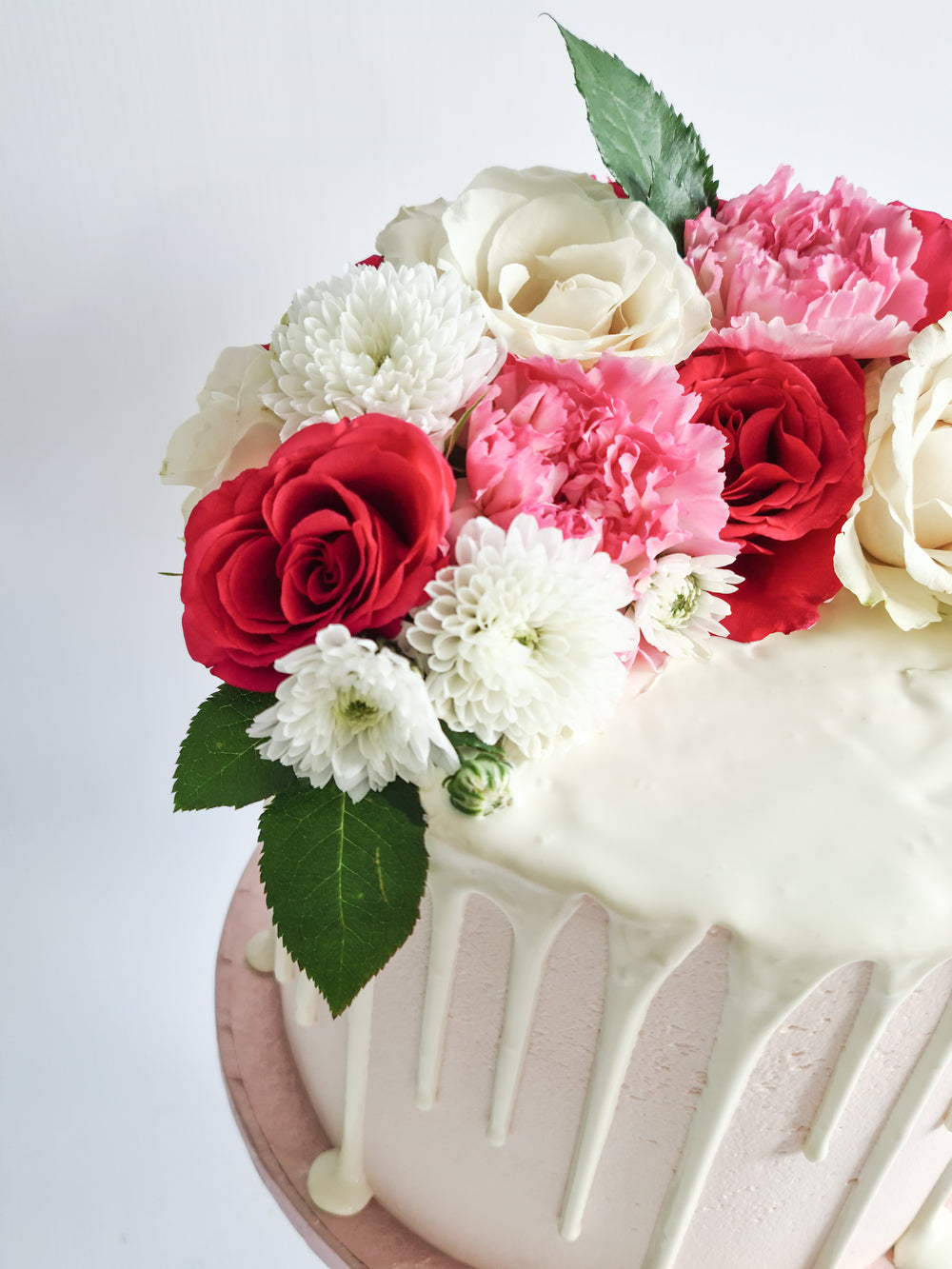 Pink fresh flower drip birthday celebration cake Isle of Man