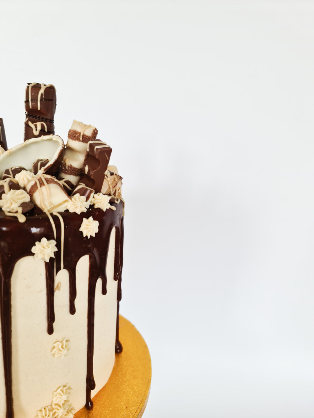 Kinder cake with milk chocolate drip and Bueno sauce for birthday celebration Isle of Man