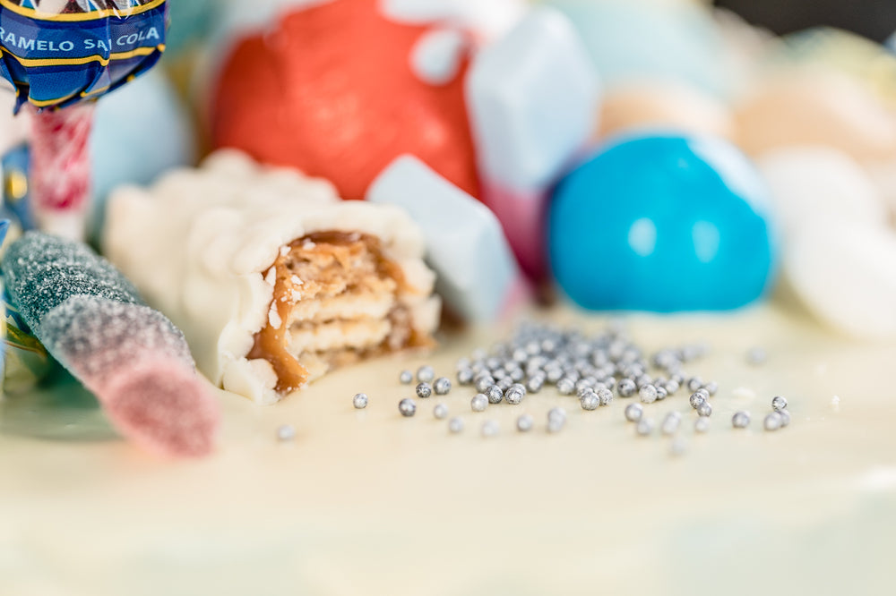 Blue fully loaded drip cake for birthday celebration on the Isle of Man
