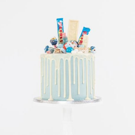 Blue fully loaded drip cake for birthday celebration on the Isle of Man